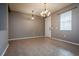 Inviting dining room featuring tile flooring, neutral walls and a modern chandelier at 7304 63Rd E Ct, Palmetto, FL 34221