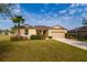 A single-Gathering home boasts a well-maintained lawn, desert landscaping, a two-car garage, and a driveway at 7304 63Rd E Ct, Palmetto, FL 34221