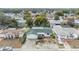 Aerial view of the property, showcasing its green roof, well-maintained lawn, and neighborhood setting at 9121 Prosperity Ln, Port Richey, FL 34668