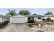 Charming one story home with a white exterior, attached garage and landscaped yard at 9121 Prosperity Ln, Port Richey, FL 34668