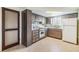 A full view of a traditional-style kitchen showcasing wooden cabinets, classic white appliances, and neutral countertops at 9121 Prosperity Ln, Port Richey, FL 34668