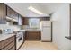 An angle view of the kitchen showcases wooden cabinets, a window, and white countertops for a functional space at 9121 Prosperity Ln, Port Richey, FL 34668