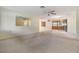 Inviting living room featuring a ceiling fan, large mirror, and an open layout at 9121 Prosperity Ln, Port Richey, FL 34668