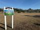 Riverside Villas welcome sign with a natural backdrop at 9337 Zamora Dr, New Port Richey, FL 34655