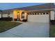 Home exterior with attached garage and driveway. Note the plants, shrubs, and updated garage door at 9337 Zamora Dr, New Port Richey, FL 34655