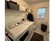 Functional laundry room featuring a washer, dryer, storage shelving, and a window for natural light at 9337 Zamora Dr, New Port Richey, FL 34655