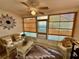 Cozy sunroom with bamboo blinds and wicker furniture at 9337 Zamora Dr, New Port Richey, FL 34655