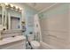 Bathroom featuring a shower-tub combo and a decorative mirror above the sink at 9417 Star Gazer Ln, Riverview, FL 33578