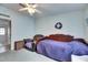 Bedroom with a comfy chair, ceiling fan, and natural light, creating a relaxing atmosphere at 9417 Star Gazer Ln, Riverview, FL 33578