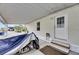 Carport with a covered motorcycle, leading to the back door of the home at 9417 Star Gazer Ln, Riverview, FL 33578