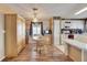 Charming dining area with wood floors, cabinetry, and views into the bright, modern kitchen at 9417 Star Gazer Ln, Riverview, FL 33578