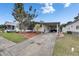 This home features a covered carport, an American flag, and a well manicured lawn at 9417 Star Gazer Ln, Riverview, FL 33578