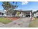 This home features a covered carport, an American flag, and a well manicured lawn at 9417 Star Gazer Ln, Riverview, FL 33578