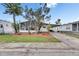 Charming home featuring a screened porch, well-manicured lawn, and covered parking at 9417 Star Gazer Ln, Riverview, FL 33578