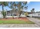 Charming home featuring a screened porch, well-manicured lawn, and covered parking at 9417 Star Gazer Ln, Riverview, FL 33578