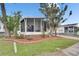 This home features a beautiful screened porch, a well manicured lawn and a brick-lined flower bed at 9417 Star Gazer Ln, Riverview, FL 33578