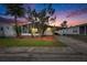 Charming home featuring a screened porch, well-manicured lawn, and covered parking at 9417 Star Gazer Ln, Riverview, FL 33578