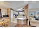 Bright kitchen featuring white cabinetry and decor with an adjacent dining space at 9417 Star Gazer Ln, Riverview, FL 33578