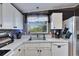 Bright kitchen with white countertops and modern appliances, showcasing a stainless steel sink at 9417 Star Gazer Ln, Riverview, FL 33578