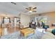 Open living room with comfortable seating, a ceiling fan, and a view of the kitchen and patio at 9417 Star Gazer Ln, Riverview, FL 33578