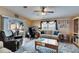 Cozy living room with a ceiling fan, comfortable seating, and a view of the screened-in patio at 9417 Star Gazer Ln, Riverview, FL 33578