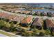 Aerial view of house featuring a clay tile roof with a screened in lanai and landscaped yard at 11309 Callisia Dr, Odessa, FL 33556