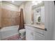 Well-lit bathroom showing tiled shower, bath tub, and vanity with stone countertop and ample cabinet storage at 11309 Callisia Dr, Odessa, FL 33556