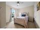Cozy bedroom with a ceiling fan, neutral walls and carpet, and a window with natural light at 11309 Callisia Dr, Odessa, FL 33556