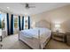 Serene bedroom featuring a bay window, neutral walls, and a comfortable queen-sized bed with side tables at 11309 Callisia Dr, Odessa, FL 33556