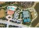 Top down aerial view of the community pool, clubhouse, tennis courts, and playground at 11309 Callisia Dr, Odessa, FL 33556