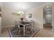 Elegant dining room with modern chandelier and a stylish rug under the table at 11309 Callisia Dr, Odessa, FL 33556