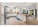 Spacious kitchen with white cabinets, stainless steel appliances, and an open layout leading to the living area at 11309 Callisia Dr, Odessa, FL 33556