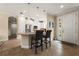 Bright kitchen featuring white cabinets, stainless steel appliances, and pendant lighting over the breakfast bar at 11309 Callisia Dr, Odessa, FL 33556