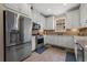 Charming kitchen featuring stainless steel appliances, white cabinetry, and stylish tile flooring at 11309 Callisia Dr, Odessa, FL 33556