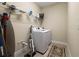 Functional laundry room with modern washer, dryer, and shelving for storage at 11309 Callisia Dr, Odessa, FL 33556