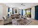 Bright living room with neutral furniture, area rug, and sliding doors leading to the outdoor space at 11309 Callisia Dr, Odessa, FL 33556