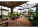 Outdoor patio area screened-in, showcasing hot tub, pavers, and relaxing seating area at 11309 Callisia Dr, Odessa, FL 33556