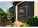 View of the screened in patio with grill and greenery at 11309 Callisia Dr, Odessa, FL 33556