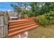 Wooden backyard deck with lounge chairs, surrounded by lush landscaping at 1155 23Rd N Ave, St Petersburg, FL 33704