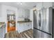 Well-lit kitchen with stainless steel refrigerator and granite countertops at 1155 23Rd N Ave, St Petersburg, FL 33704