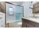 Well-lit bathroom with shower over tub and sleek vanity with marble countertop at 120 60Th Ave, St Pete Beach, FL 33706