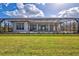 Expansive backyard featuring a screened-in pool area and lush green lawn at 1201 Blue Shell Loop, Sarasota, FL 34240