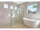 Spa-like bathroom with soaking tub, glass shower, and large window offering lots of natural light at 1201 Blue Shell Loop, Sarasota, FL 34240