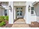 Close up of the front door entrance with brick pavers and decorative lanterns at 1201 Blue Shell Loop, Sarasota, FL 34240