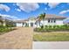 Stunning exterior of a two-story home featuring a well-manicured lawn and a beautiful brick driveway at 1201 Blue Shell Loop, Sarasota, FL 34240
