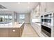 Modern kitchen with stainless steel appliances, a large island, and ample counter space at 1201 Blue Shell Loop, Sarasota, FL 34240
