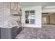 Gourmet outdoor kitchen with stainless steel grill, sink, and modern finishes on a brick-paved patio at 1201 Blue Shell Loop, Sarasota, FL 34240