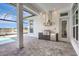 Outdoor kitchen featuring stainless steel appliances, vent hood and island, set up to entertain guests at 1201 Blue Shell Loop, Sarasota, FL 34240