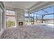Relaxing outdoor living space features a cozy fireplace and beautiful views of the surrounding lake at 1201 Blue Shell Loop, Sarasota, FL 34240