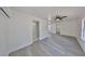 A bright bedroom featuring gray wood-look flooring, a ceiling fan, and neutral walls at 1303 E New Orleans Ave, Tampa, FL 33603